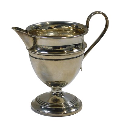 Lot 644 - A George V silver cream jug, on a circular...
