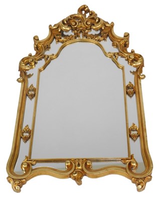 Lot 784 - A gilt composition wall mirror, with rococo...