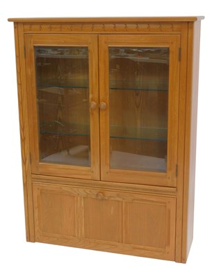 Lot 790 - An Ercol elm unit, two doors with bevelled...