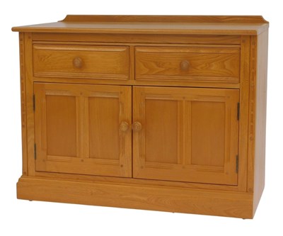 Lot 791 - An Ercol elm side cabinet, with two frieze...