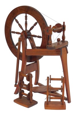 Lot 826 - A mahogany spinning wheel, with tapering...