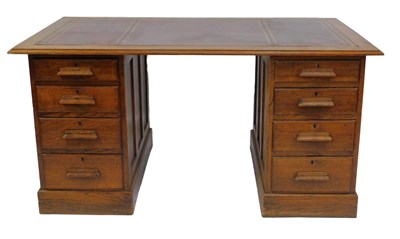 Lot 850 - An early 20thC oak kneehole desk, the...