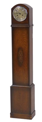 Lot 851 - A 1920s oak cased grandmother clock, with...