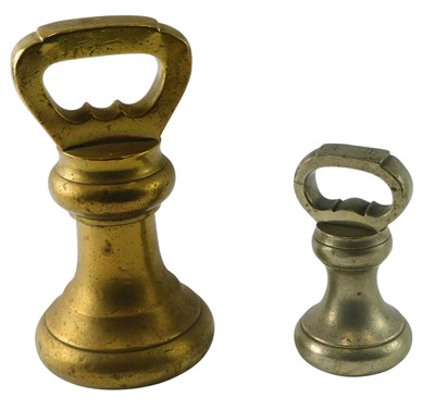 Lot 127 - A large brass fourteen pound weight, 32cm high,...