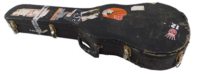 Lot 232 - A vacant guitar case, bearing various labels,...