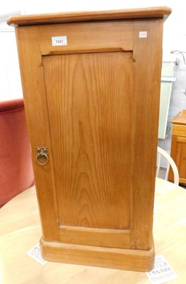 Lot 1521 - A pine bedside cabinet, single door and two...