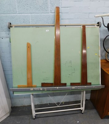 Lot 1504 - A draftsman's folding table, with steel legs,...