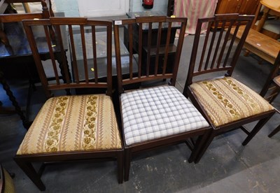 Lot 1557 - Three Georgian mahogany dining chairs, with...