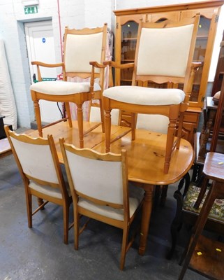 Lot 1560 - A pine extending dining table, on turned legs,...