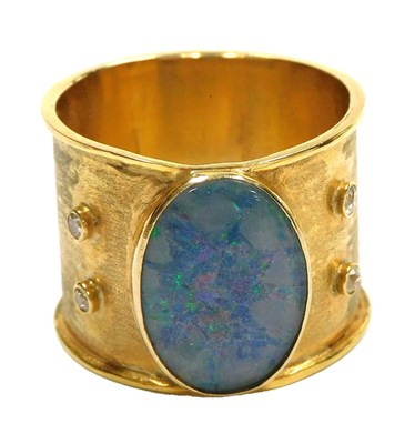 Lot 14 - A gentleman's opal ring, the oval cut stone...