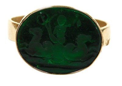 Lot 333 - A green glass intaglio ring, of oval form,...