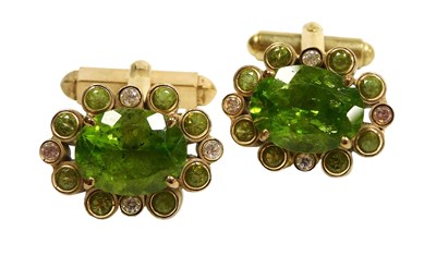 Lot 321 - A pair of peridot and CZ cufflinks, the oval...