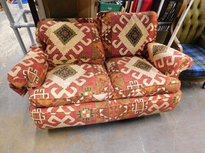 Lot 1588 - A two seater cloth covered sofa, with South...