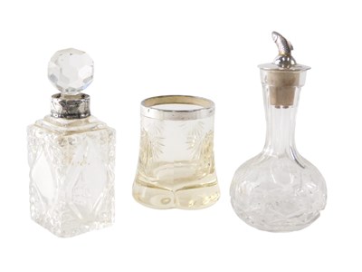 Lot 530 - A cut glass bottle, the silver stopper cast...