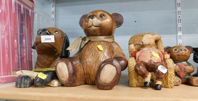 Lot 2005 - A carved wooden dog, chewing a bone, together...