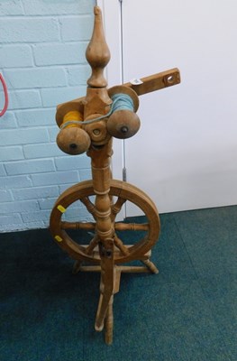 Lot 2032 - A wooden spinning wheel.