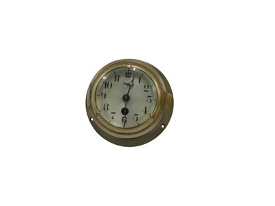 Lot 867 - A silver plated bulk head clock, with...