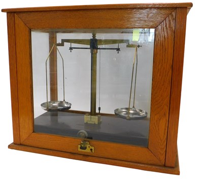 Lot 908 - A set of brass chemist scales, in oak cabinet,...