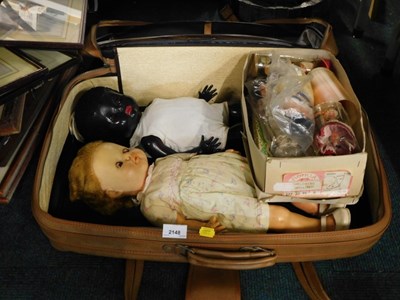 Lot 2148 - A suitcase, containing various miniature dolls...