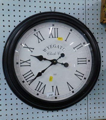 Lot 2187 - A Wyegate Clock Company wall clock, black...