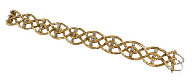 Lot 50 - An 18ct gold and diamond bracelet, in a plait...