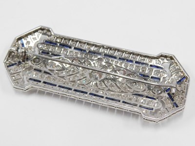 Lot 59 - An Art Deco diamond and sapphire panel brooch,...