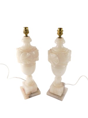 Lot 1024 - A pair of carved onyx table lamps, each...