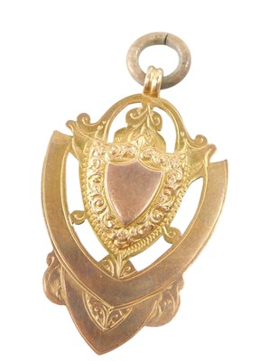 Lot 613 - A 9ct gold shield medallion, 6.1g.
