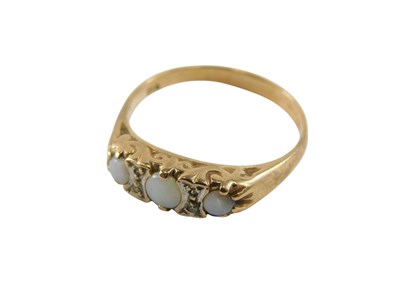 Lot 94 - A 9ct gold and opal three stone ring, set with...