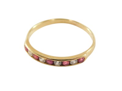 Lot 88 - A ruby and cz nine stone ring, in a rub over...