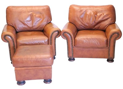 Lot 1069 - A pair of brown leather armchairs, with brass...
