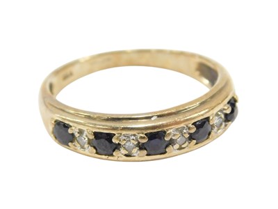 Lot 620 - A 9ct gold sapphire and diamond nine stone...