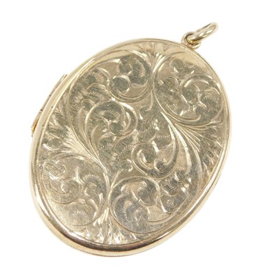 Lot 634 - A 9ct gold oval pendant locket, with engraved...