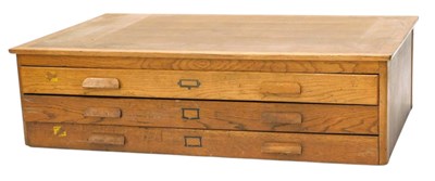 Lot 1095 - The top section of light oak plan chest, with...