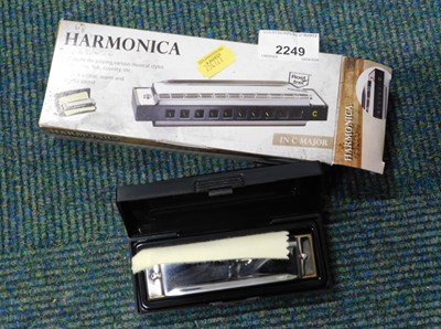 Lot 2249 - A harmonica, boxed.