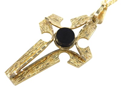 Lot 599 - A black onyx set cross pendant, in yellow...