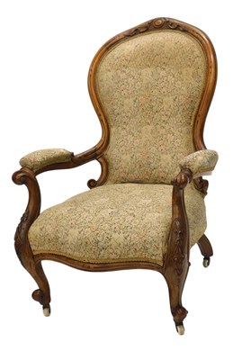 Lot 1101 - A Victorian walnut spoon back open armchair,...