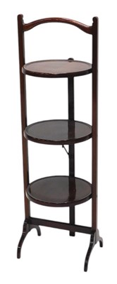 Lot 1103 - An Edwardian walnut three tier folding cake...