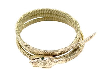 Lot 64 - A coiled serpent bangle, with emerald set eyes,...