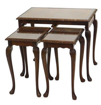 Lot 902 - A nest of three walnut occasional tables, each...