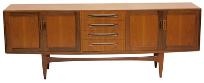 Lot 1115 - A 1970s teak low sideboard, with an...