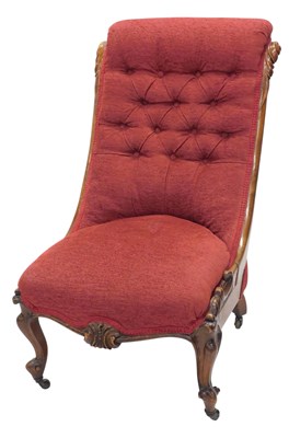 Lot 1130 - A Victorian walnut nursing chair, with a...