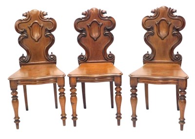 Lot 1131 - A set of three Victorian mahogany hall chairs,...