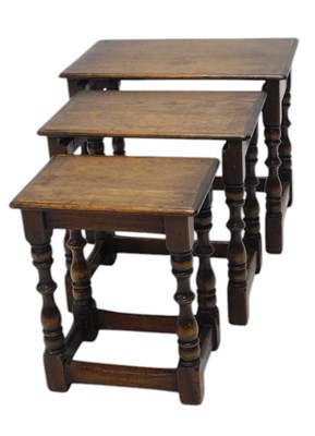 Lot 1150 - A nest of three oak occasional tables, each...