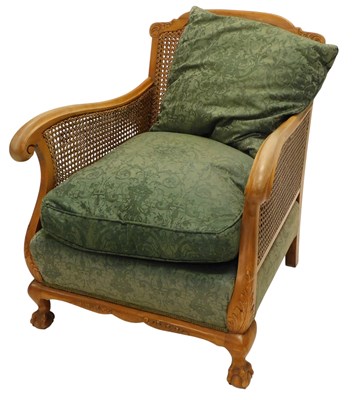 Lot 1155 - An early 20thC walnut bergere armchair, with...