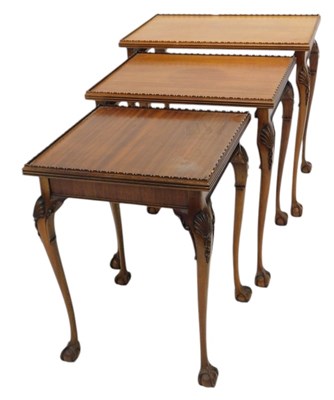 Lot 1158 - A nest of three walnut occasional tables, each...