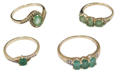 Lot 665 - Four yellow metal dress rings, each set with a...