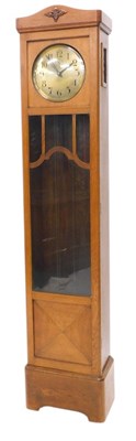 Lot 1049 - A 1920s/30s oak longcase clock, the silvered...