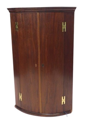 Lot 1071 - A 19thC mahogany bowfronted corner cabinet,...