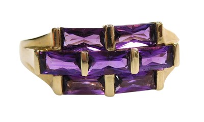 Lot 579 - A 9ct gold and amethyst seven stone ring, set...